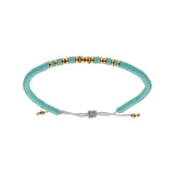 Bracelet acier cordon coulissant rondelles turquoise imitation et boules dorées